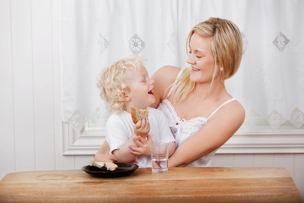 toddler food ideas - mother looking at boy eating bread