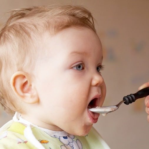 toddler being fed