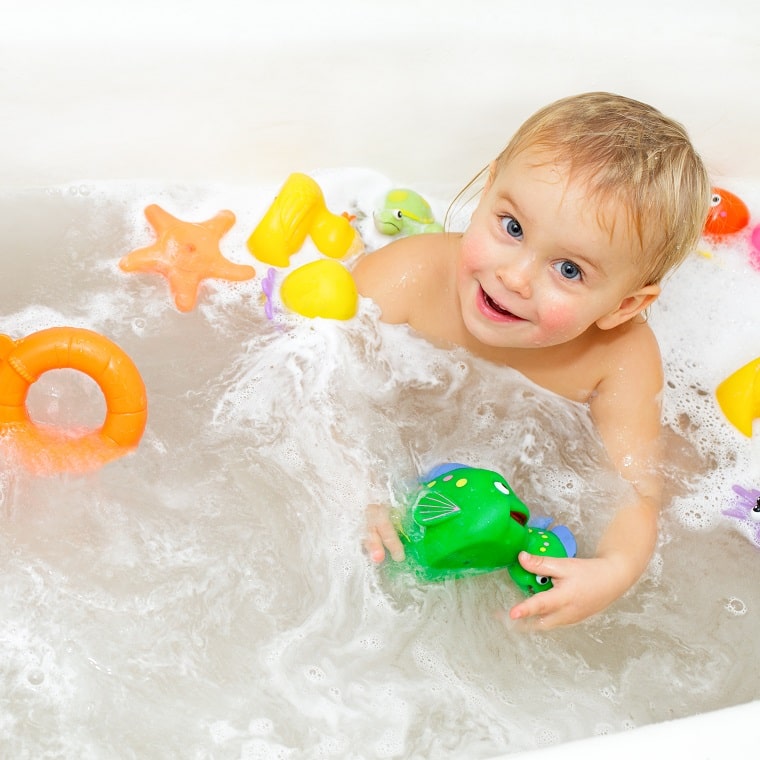 baby taking a bath with toys for toddlers