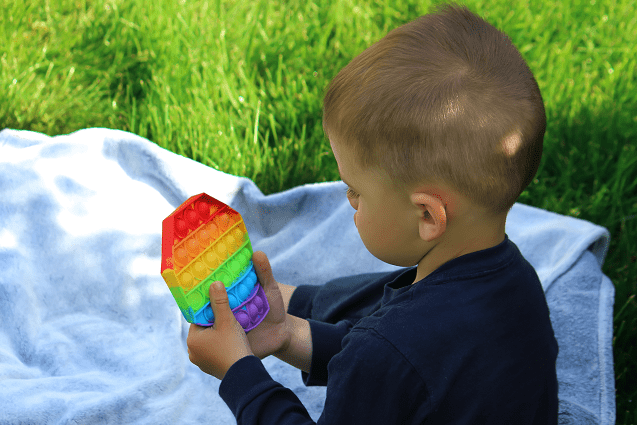 sensory-activities-for-toddlers-toddler-playing-with-pop-it-anti-stress-toy