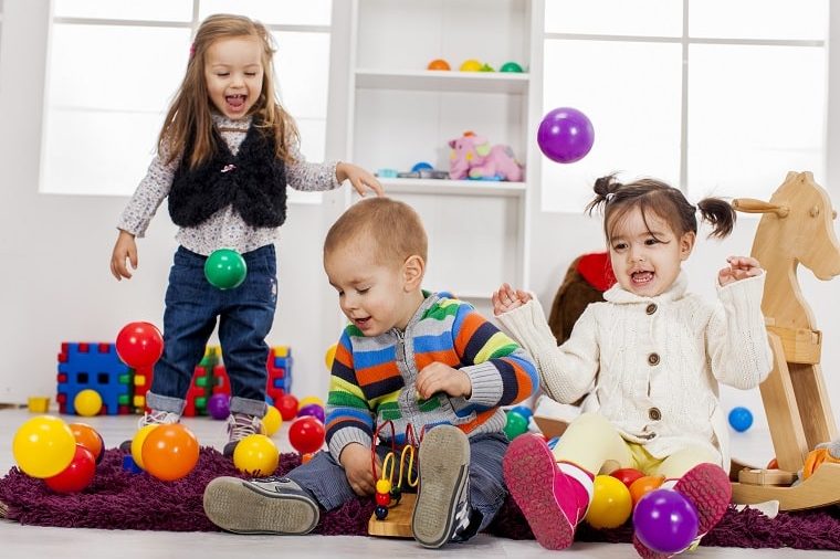 play based learning - toddlers happily playing with plastic balls