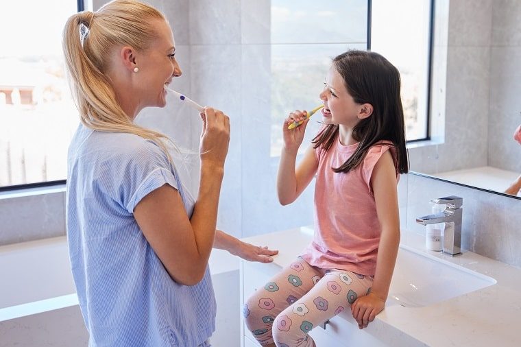 daily routines for kids - mother and child brushing teeth together
