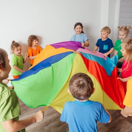 group games for preschoolers - kids playing parachute game