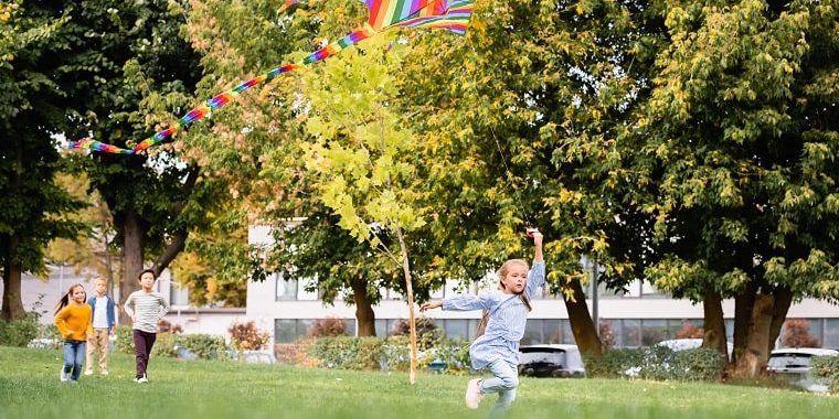 outdoor activities for preschoolers – children playing at the park with a kite outdoor activities for preschoolers - children playing at the park with a kite