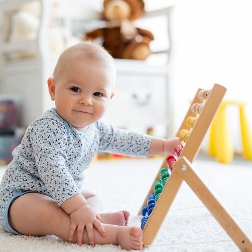math activities for toddlers - toddler playing with the abacus