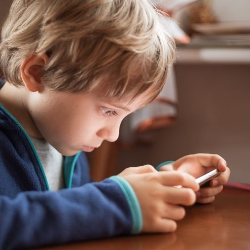 outdoor play – boy using cellphone outdoor play - boy using cellphone