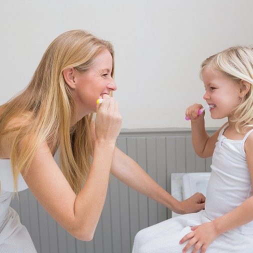 how do routines help a child’s development – mother and child brushing teeth together how do routines help a child's development - mother and child brushing teeth together