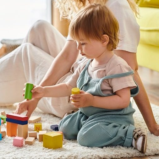 Language development for toddlers – child playing wooden blocks Language development for toddlers - child playing wooden blocks