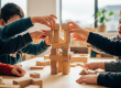 Children's hands collaboratively building with wooden blocks, demonstrating social skill development at Sunshine Coast early learning centre