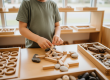 Child developing fine motor skills and pattern recognition through natural material play at Sunshine Coast early learning centre
